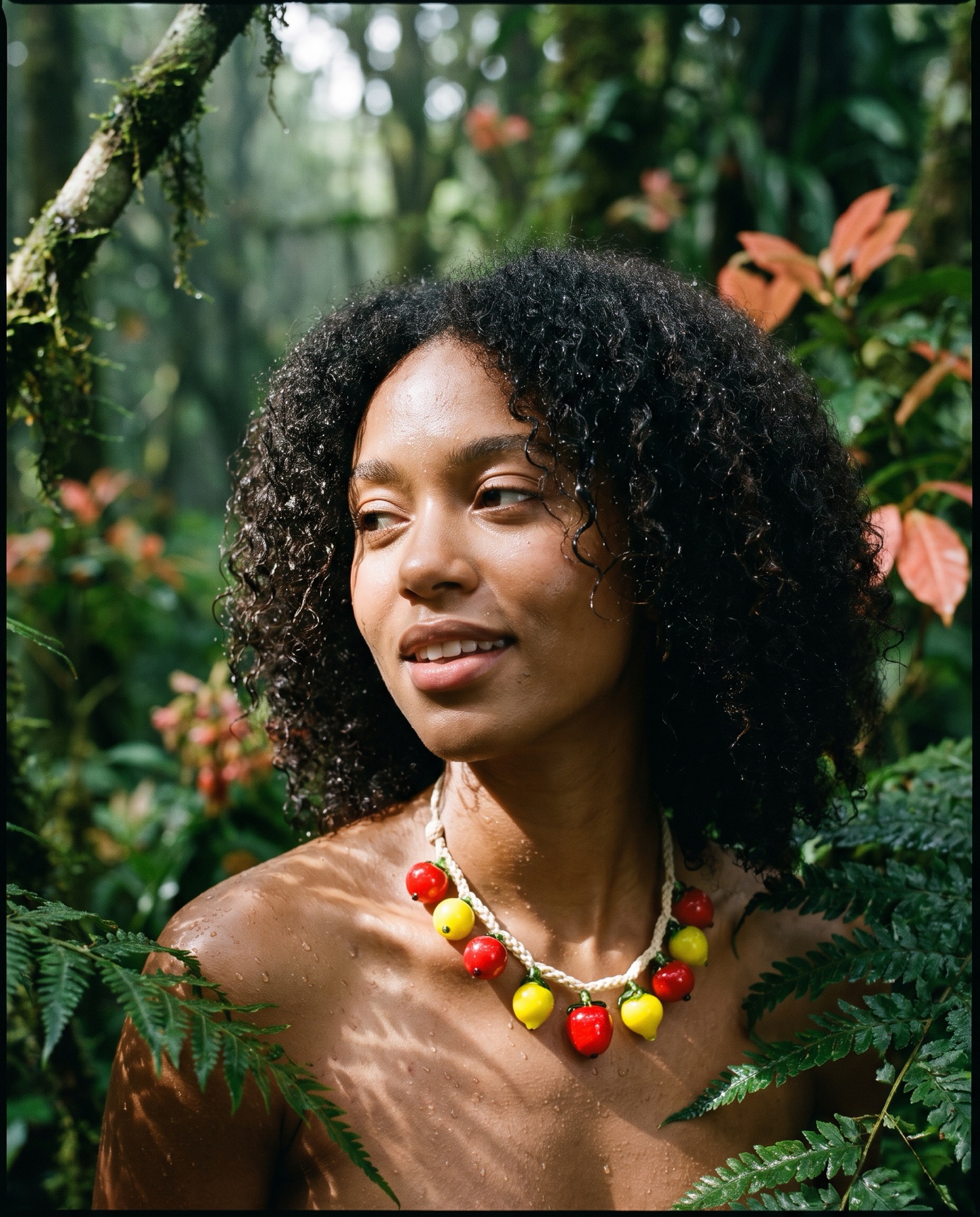 Model wearing the Fruit Salad necklace in forest light